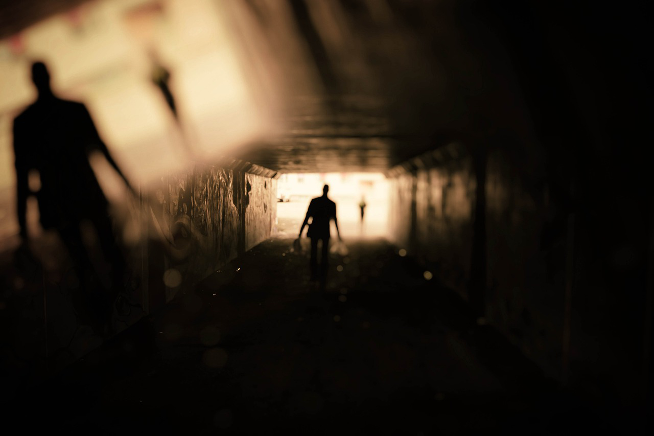 How to Promote Horror: a dark, shadowy person at the end of a tunnel.